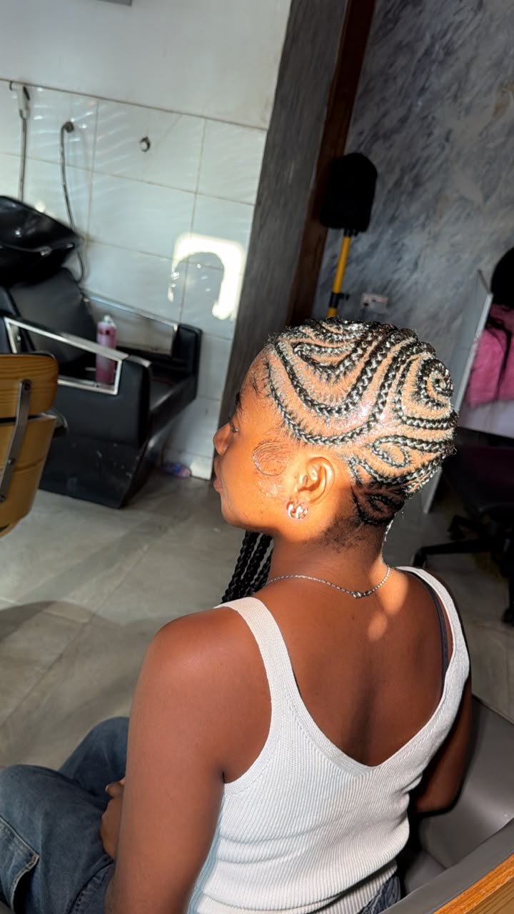 Intricate braided hairstyle at Cilla's Hub Beauty Salon